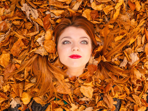 Beautiful girl between leaves.
