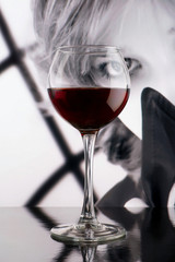 Red wine glass against black and white girl poster