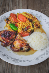 Papaya Salad with Grilled Chicken and Sticky Rice on Wood Backgr