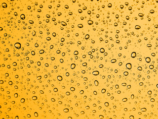 Rian drops on glass, Gold yellow color background.