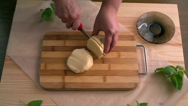 Cutting of cheese. Preparation of pizza on an unleavened wheat cake with chicken fillet.