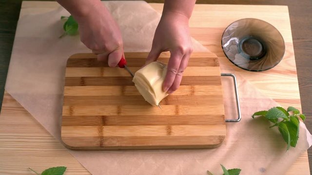 Cutting of cheese. Preparation of pizza on an unleavened wheat cake with chicken fillet.