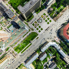 Fototapeta premium Aerial city view with crossroads and roads, houses, buildings, parks and parking lots, bridges. Copter shot. Panoramic image.