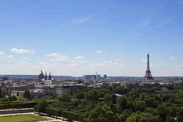 Aerial view of Eiffel tower and Paris city from Jardin Des Tuileries vith clear, blue sky.