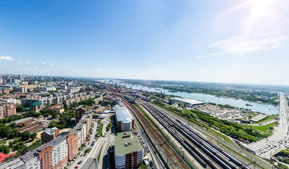 Aerial city view with crossroads, roads, houses, buildings, parks and parking lots. Copter drone helicopter shot. Panoramic wide angle image.