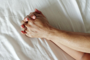 Fototapeta premium hand of women pulling white sheets in ecstasy, orgasm.
