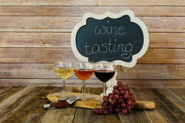 Wine flight with chalkboard sign and grapes