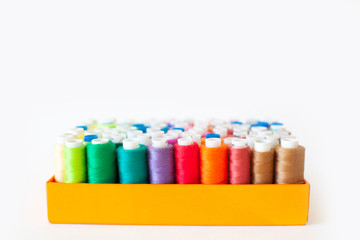 Colored thread for sewing. Threads in spools tape measure.