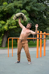 Fototapeta premium Man Performing Bag Squat Exercise Outdoor