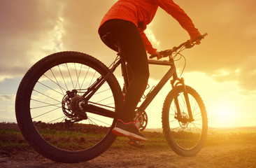 Fototapeta na wymiar Cyclist riding a bike in the sunset.