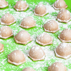 Small homemade dumplings of coarse whole wheat flour. Shallow depth of field