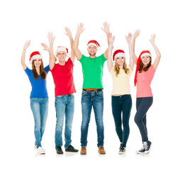 Group of smiling friends in Christmas hats