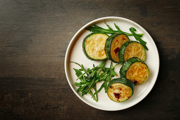 Baked squash slices in plate on table