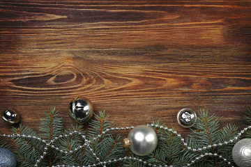 Christmas composition with fir tree branches and festive decoration on wooden background