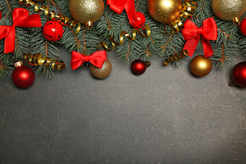 Christmas composition with fir tree branches and festive decoration on gray background