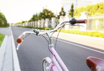 Fototapeta na wymiar Bicycle on asphalt road, close up view