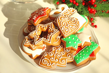 Plate with tasty gingerbread cookies on table, close up view
