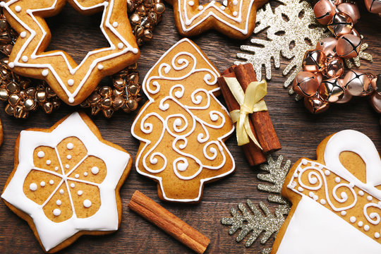 Tasty Gingerbread Cookies And Christmas Decor On Wooden Background, Close Up