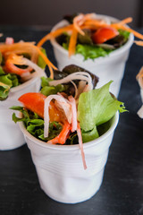 Salad for health in white cup on table