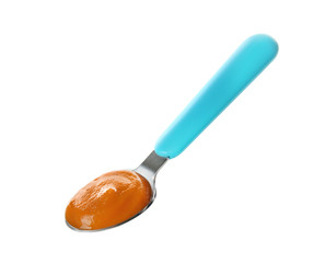 Bright spoon with baby puree on white background