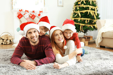 Fototapeta na wymiar Happy family in living room decorated for Christmas