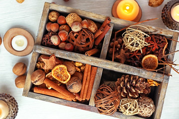 Wooden basket with Christmas decoration, nuts and spices, closeup