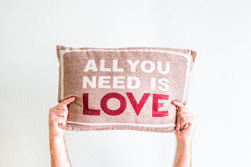 Man Hands Holding A Pillow With A Love Message Isolated In White Background