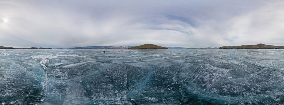 360 panorama blue ice of Lake Baikal covered with cracks, cloudy
