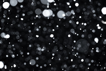 Falling snow on black background.