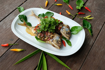 fried mackerel fish and chilli sauce on white plate