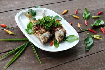 fried mackerel fish and chilli sauce on white plate