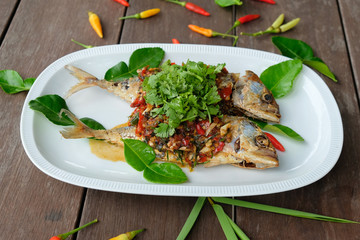 fried mackerel fish and chilli sauce on white plate