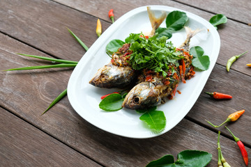 fried mackerel fish and chilli sauce on white plate