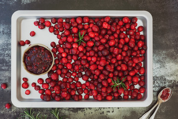 Cranberry jam and fresh cranberries on a baking tray