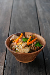 Stir fried chicken with spicy curry paste on wood plate/ Thai fo