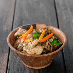 Stir fried chicken with spicy curry paste on wood plate/ Thai fo