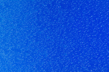 Fototapeta na wymiar water drop on blue background