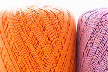 Orange and purple knitting thread background. Bright handiwork backdrop, colorful crochet string, Leisure, hobby, needlework concept