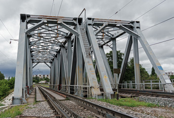 Railway bridge on a background of the cloudy sky