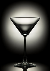 Empty martini glass on a color background.