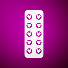 Flat design love pills. Pills in the shape of a heart in a blister pack flat icon on purple background. Vector Illustration