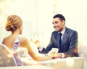 couple with glasses of champagne at restaurant