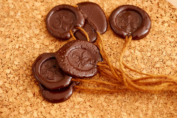 Seal of brown wax on the background surface of balsa wood