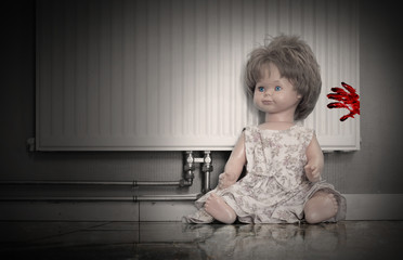 Concept of child abuse - Bloody doll