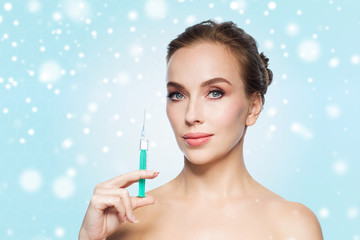 beautiful woman holding syringe with injection