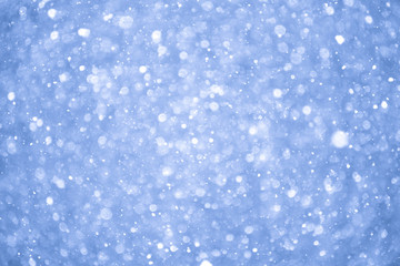 Abstract Blue Christmas Background with Real Snow. Blurred Snowflakes.