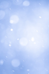 Abstract Blue Christmas Background with Real Snow. Blurred Snowflakes.