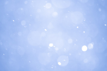 Obraz premium Abstract Blue Christmas Background with Real Snow. Blurred Snowflakes.