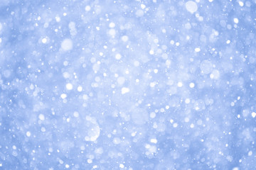 Abstract Blue Christmas Background with Real Snow. Blurred Snowflakes.
