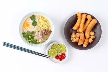 Rice porridge with mined pork and chicken lever served with side dish as Patongko (deep-fried dough stick) and spicy sour filling.

